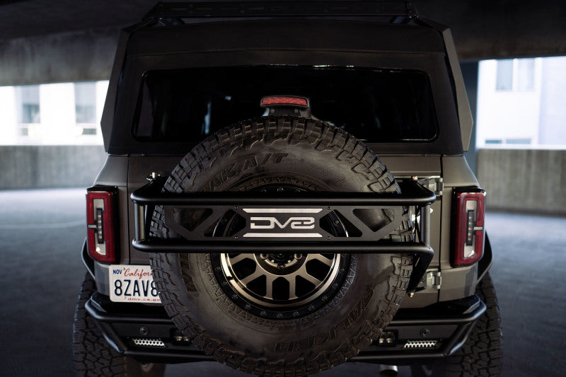 Load image into Gallery viewer, DV8 Offroad 21-23 Ford Bronco Spare Tire Guard &amp; Accessory Mount

