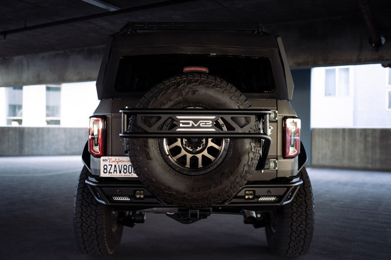 Load image into Gallery viewer, DV8 Offroad 21-23 Ford Bronco Spare Tire Guard &amp; Accessory Mount
